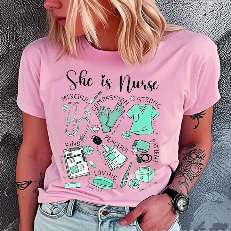 A woman wearing a light pink graphic t-shirt with the text 'She is Nurse' and illustrations of medical supplies and badges in mint green, paired with light blue jeans.